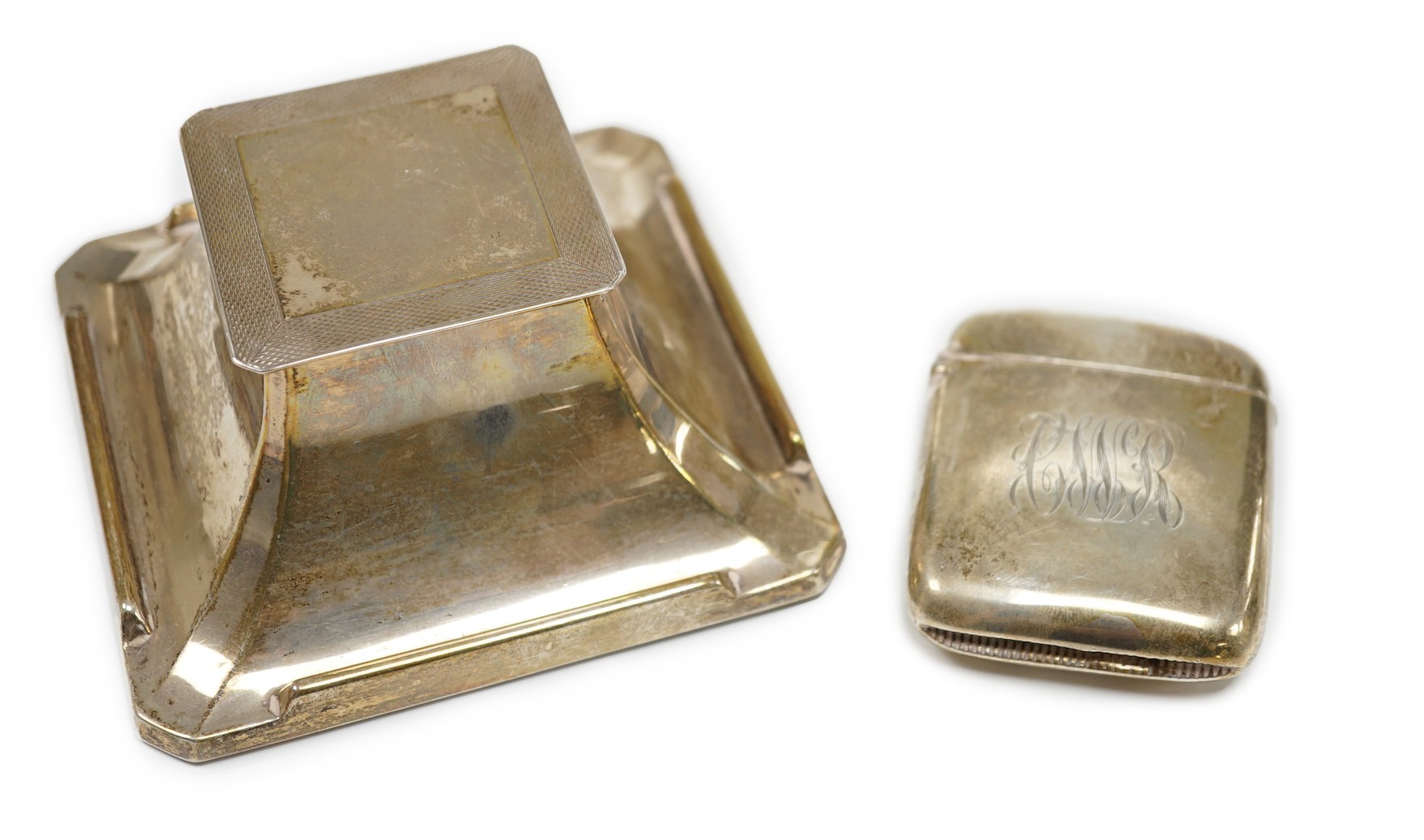 A 1930's Art Deco part engine turned silver mounted inkwell, 10.2cm and a large silver vesta case.